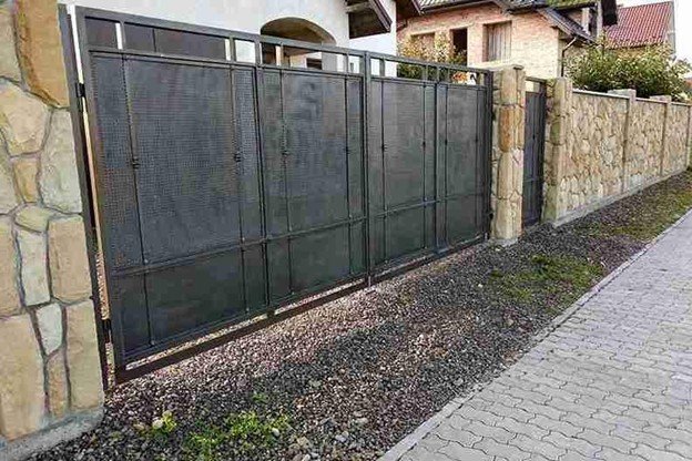 New metal driveway gate installed and aligned correctly for smooth operation at a residential property