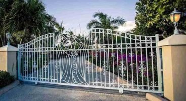 Decorative metal automatic driveway gate installed at a residential property entrance